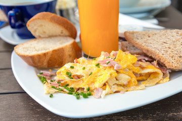 Breakfast with orange juice and fresh omelet on table