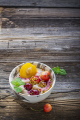 Healthy breakfast snack. Marble bowl full of fresh cherry smoothie with natural yogurt, berries and flower bee pollen. selective focus