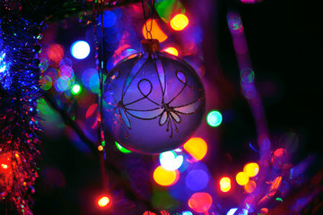 Christmas ball on the Xmas tree with bokeh color lights background. Soft and selective focus. - 130815809