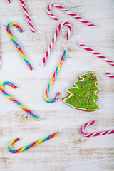 Gingerbread and candy canes on a  wooden background. Christmas s