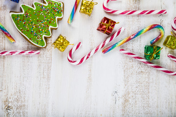 Gingerbread and candy canes on a  wooden background. Christmas s