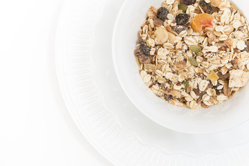 Bowl of muesli with dry fruits, on white,background.