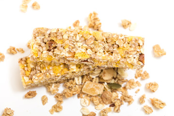 Granola energy bars with nuts and dry fruits, on white background.