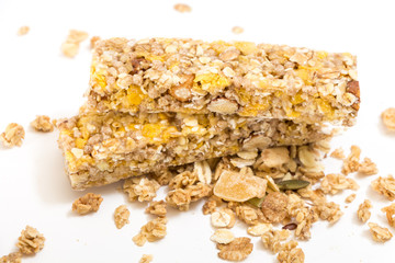 Granola energy bars with nuts and dry fruits, on white background.
