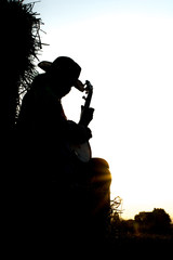 .A young man playing the banjo The straw in the field The golden