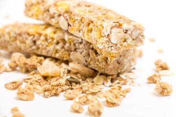 Granola energy bars with nuts and dry fruits, on white background.