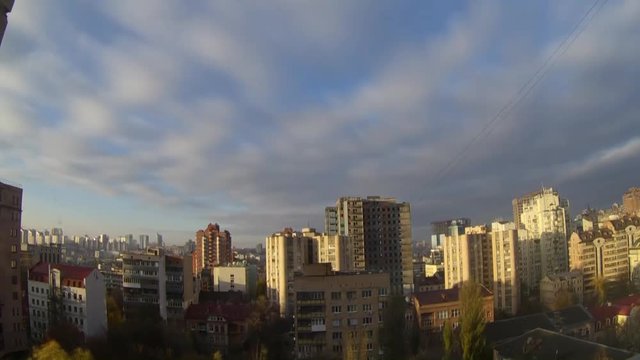 time-lapse video sunset sky with clouds colored red, yellow. blue, cyan color sunrise above the city and over builds 
