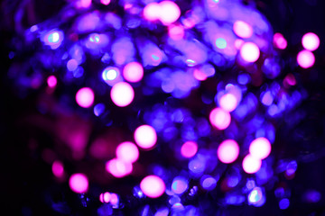 Glitter lights background. Holiday bokeh texture. Multicolored light. Defocused