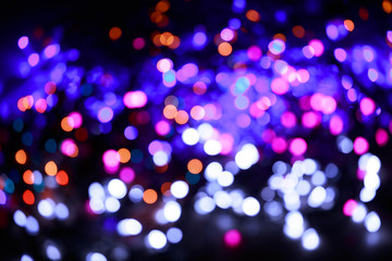 Glitter lights background. Holiday bokeh texture. Multicolored light. Defocused