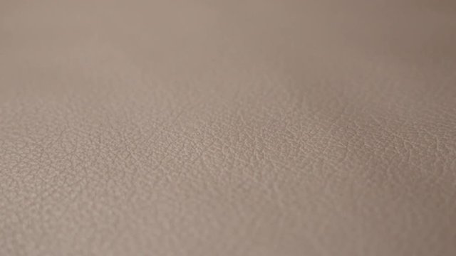 Slow tilt over real leather sofa surface 4K 3840X2160 UHD footage - Contemporary dark natural fabric texture shallow DOF 2160p UHD tilting video 