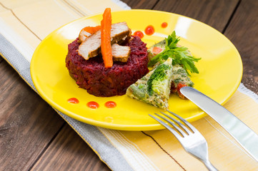 Tasty and fresh dinner with stewed beets, roasted meat, carrots  Spanish omelette. Wooden table. Top view