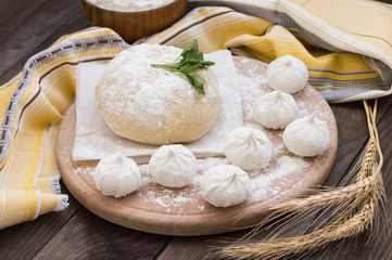 Raw khinkali in the kitchen. The process of preparing hinkaley. Closeup. Top view