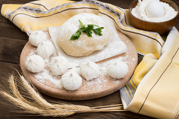 Raw khinkali in the kitchen. The process of preparing hinkaley. Closeup. Top view