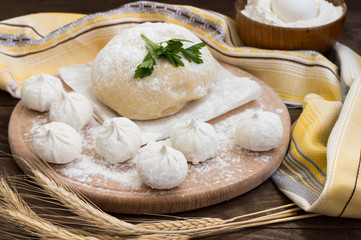 Raw khinkali in the kitchen. The process of preparing hinkaley. Closeup. Top view