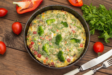 Spanish tortilla in the pan. Wooden rustic table. Top view