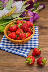 Strawberries in the basket on wooden background