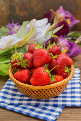 Strawberries in the basket on wooden background