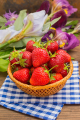 Strawberries in the basket on wooden background