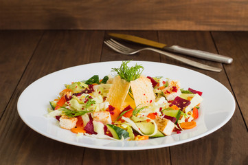 Vegetarian salad with vegetables and cheese crisps. Wooden table. Close-up