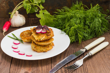 Potato pancakes for breakfast. Wooden rustic background