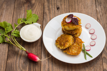 Potato pancakes for breakfast. Wooden rustic background