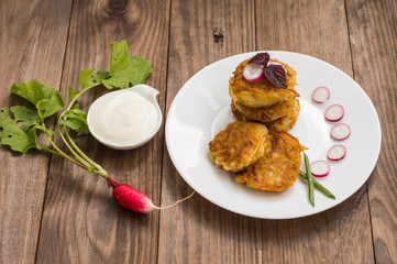 Potato pancakes for breakfast. Wooden rustic background