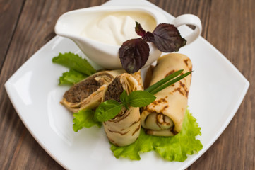 Pancakes with a liver on  wooden table. Restaurant supply. Top view. Close-up