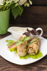 Pancakes with a liver on  wooden table. Restaurant supply. Top view. Close-up