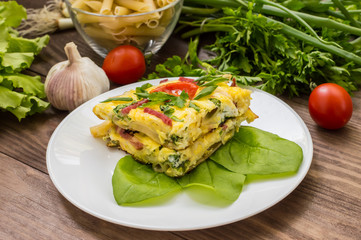 Frittata in Italian on a wooden table. Top view. Close-up