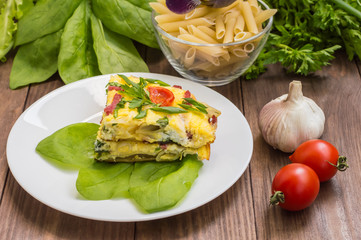 Frittata in Italian on a wooden table. Top view. Close-up