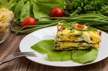 Frittata in Italian on a wooden table. Top view. Close-up