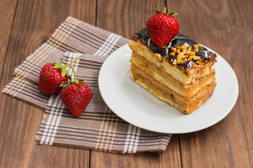Fresh cream cake slice on a wooden table. Top view. Close-up