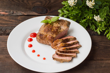 Rare Beef steak medium grilled with barbecue sauce. Wooden table. Top view. Close-up
