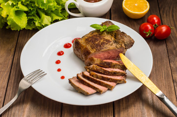 Rare Beef steak medium grilled with barbecue sauce. Wooden table. Top view. Close-up