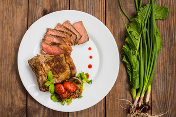 Rare Beef steak medium grilled with barbecue sauce. Wooden table. Top view. Close-up