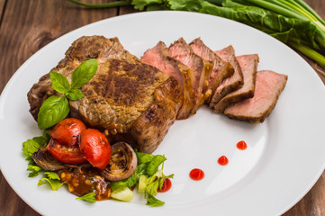 Rare Beef steak medium grilled with barbecue sauce. Wooden table. Top view. Close-up