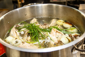 The soup is cooked in a large pot in the kitchen in the restaura