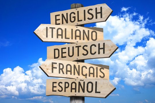 Wooden signpost - languages concept - "English, Italiano, Deutsch, Francais, Espaniol" (English, Italian, German, French, Spanish) - "English, Italian, German, French, Spanish" (English.