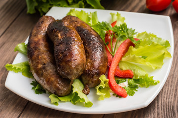 Bavarian sausages cooked on the grill. Wooden table