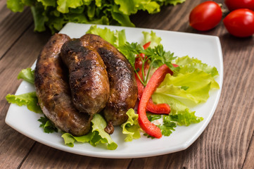 Bavarian sausages cooked on the grill. Wooden table