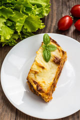 Lasagna, traditional Italian food on a wooden background