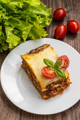 Lasagna, traditional Italian food on a wooden background