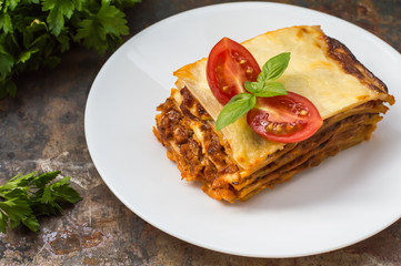 Lasagna, traditional Italian food on a wooden background