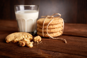 Cookies and milk. Chocolate chip cookies and a glass of milk. Vintage look. Tasty cookies and glass of milk on rustic wooden background. Food, junk-food, culinary, baking and eating concept
