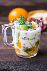 Yogurt with fruit in a glass for breakfast. Old background. Top view. Close-up