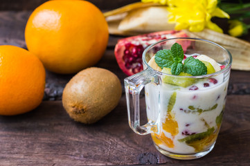 Yogurt with fruit in a glass for breakfast. Old background. Top view. Close-up