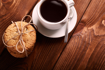 Coffee and Homemade cookies with chocolate. Handmade Chocolate cookies and cup of espresso on wooden table. Pile of delicious chip cookies. Christmas cookies. Biscuits. Oat biscuits.