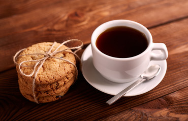 Coffee and Homemade cookies with chocolate. Handmade Chocolate cookies and cup of espresso on wooden table. Pile of delicious chip cookies. Christmas cookies. Biscuits. Oat biscuits.