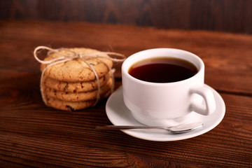 Coffee and Homemade cookies with chocolate. Handmade Chocolate cookies and cup of espresso on wooden table. Pile of delicious chip cookies. Christmas cookies. Biscuits. Oat biscuits.