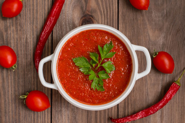Gazpacho with vegetables. Wooden rustic background. Top view